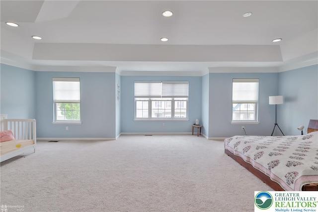 carpeted bedroom with a tray ceiling, baseboards, and recessed lighting