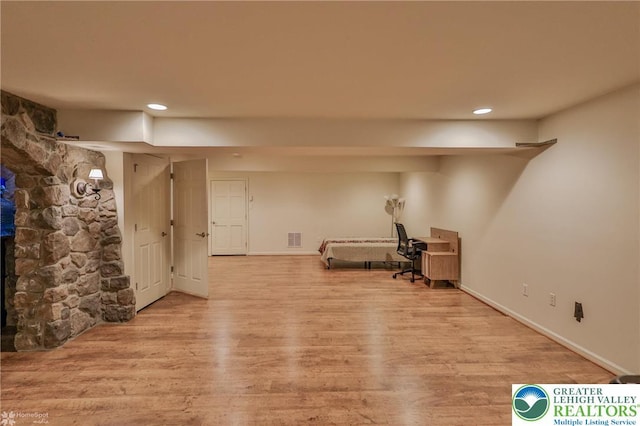 finished below grade area featuring visible vents, wood finished floors, baseboards, and recessed lighting