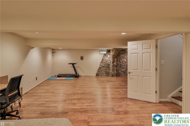 workout room with recessed lighting, baseboards, and light wood-style floors