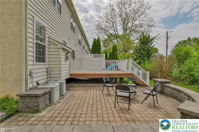 view of patio / terrace with central AC and a deck