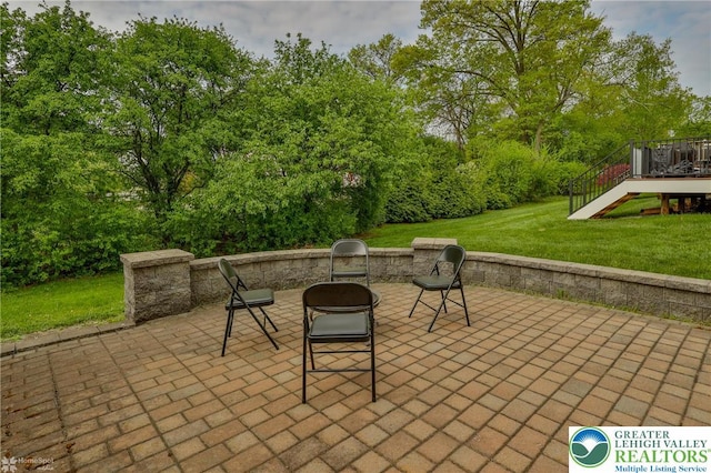 view of patio / terrace with an outdoor fire pit, stairway, and a wooden deck