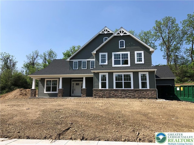 craftsman-style house with covered porch and stone siding