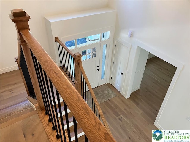 entryway featuring baseboards and wood finished floors