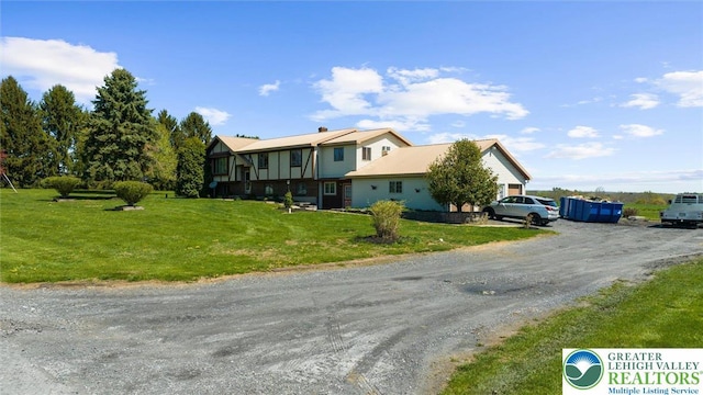 view of front of house featuring a front lawn and driveway