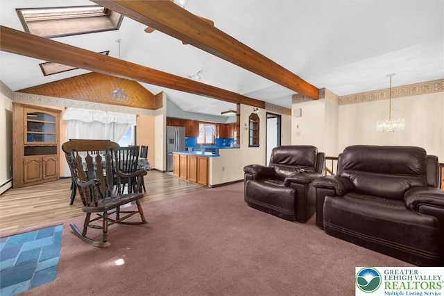 living area with baseboards, an inviting chandelier, lofted ceiling with beams, and wood finished floors