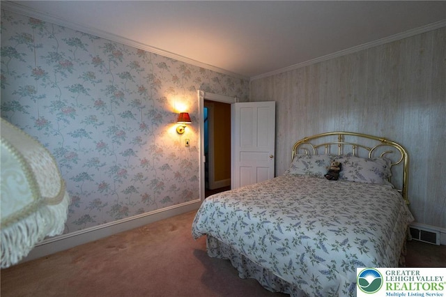 carpeted bedroom with crown molding, baseboards, and visible vents