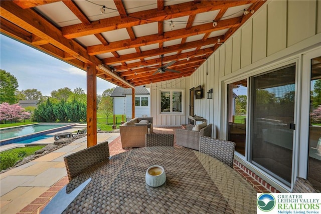 view of patio featuring a ceiling fan, outdoor dining area, and an outdoor pool