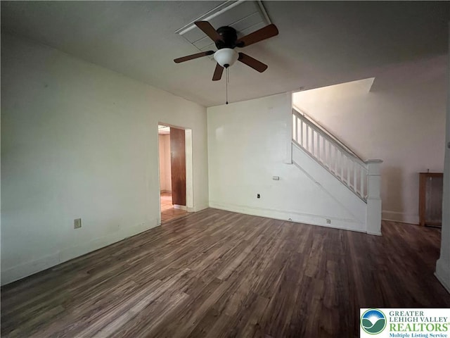 unfurnished living room featuring baseboards, a ceiling fan, stairs, and wood finished floors
