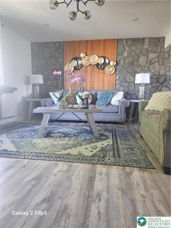 living room featuring an inviting chandelier and wood finished floors