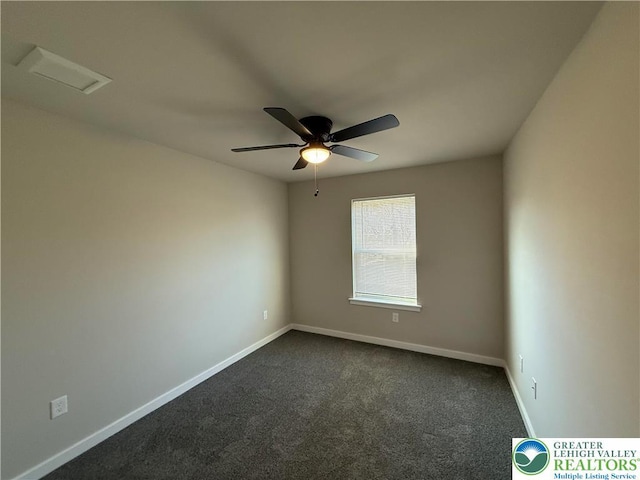 spare room featuring a ceiling fan, baseboards, and dark carpet