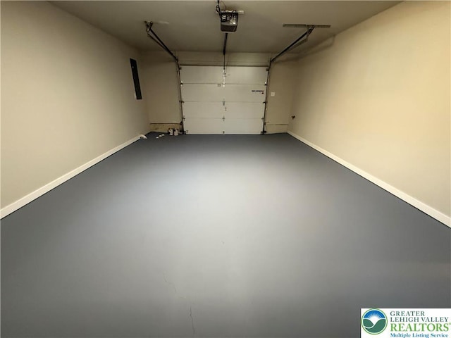 garage with baseboards and a garage door opener