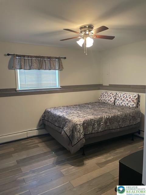 bedroom featuring a ceiling fan and wood finished floors