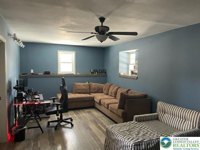 home office with a ceiling fan and wood finished floors