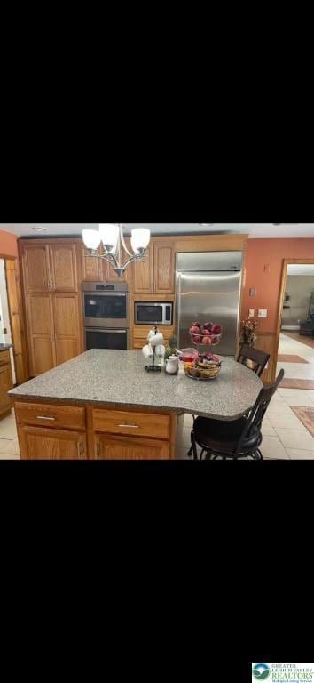 kitchen featuring light countertops, stainless steel appliances, and a chandelier