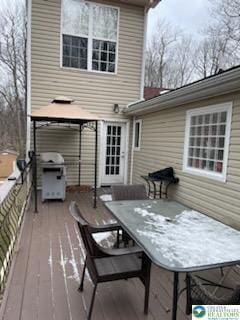 back of property with outdoor dining area and a gazebo