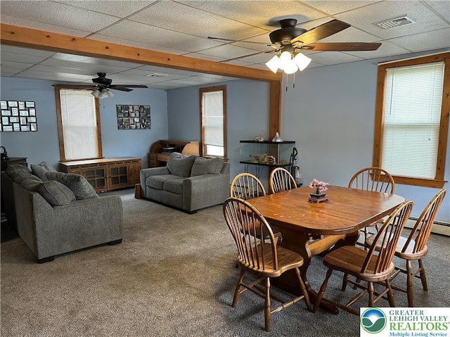 dining room with carpet floors, ceiling fan, visible vents, and a drop ceiling