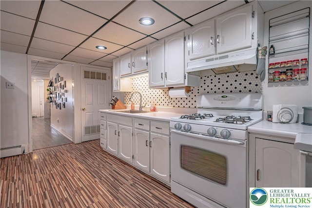 kitchen featuring wood finished floors, a sink, light countertops, white gas range oven, and under cabinet range hood