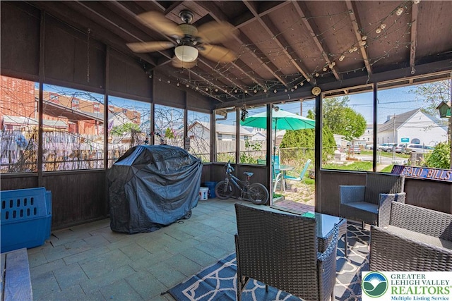 sunroom featuring ceiling fan