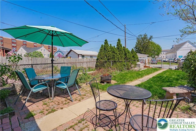 view of patio / terrace featuring outdoor dining area, an outdoor fire pit, and fence