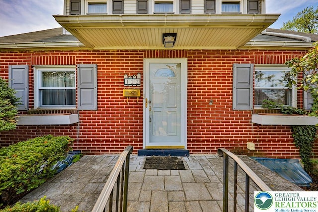 entrance to property with brick siding