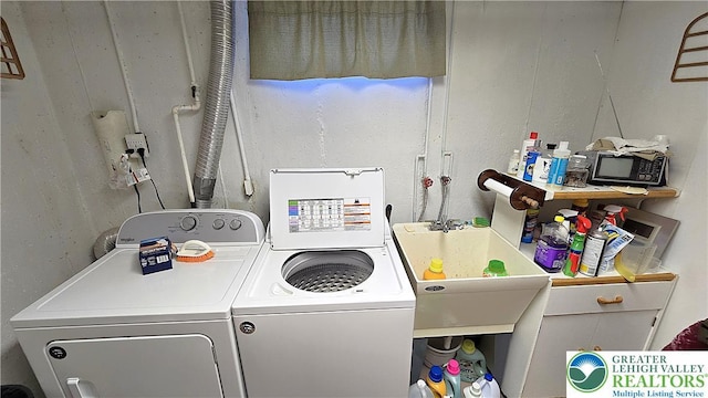 laundry room featuring separate washer and dryer and laundry area