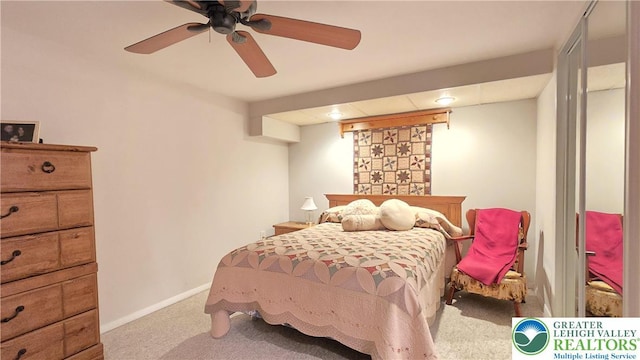 carpeted bedroom with baseboards and ceiling fan