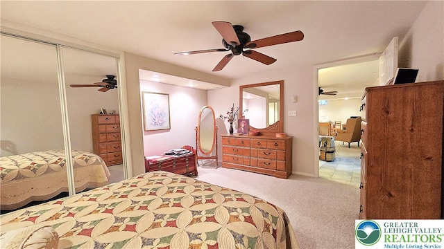 bedroom featuring a ceiling fan, carpet, and a closet