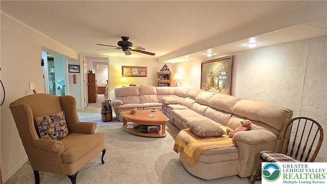 carpeted living room featuring a ceiling fan