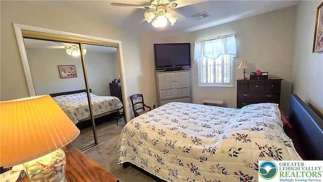 bedroom featuring visible vents, carpet, ceiling fan, and a closet
