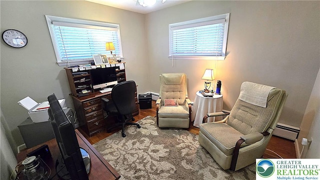office space with baseboard heating and wood finished floors