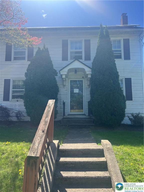 8204 Brown St, Washington Twp, PA 18079 - view of front of house featuring a chimney and a front yard