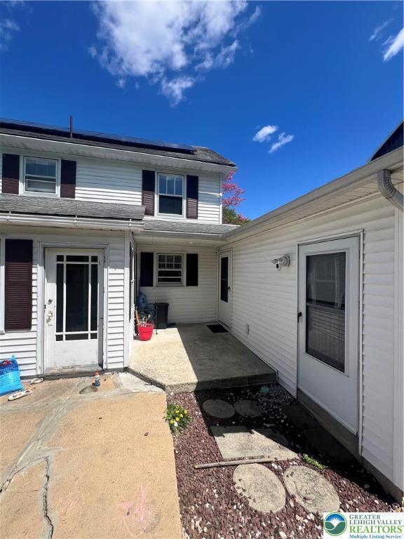 8204 Brown St, Washington Twp, PA 18079 - back of house featuring a patio and roof mounted solar panels