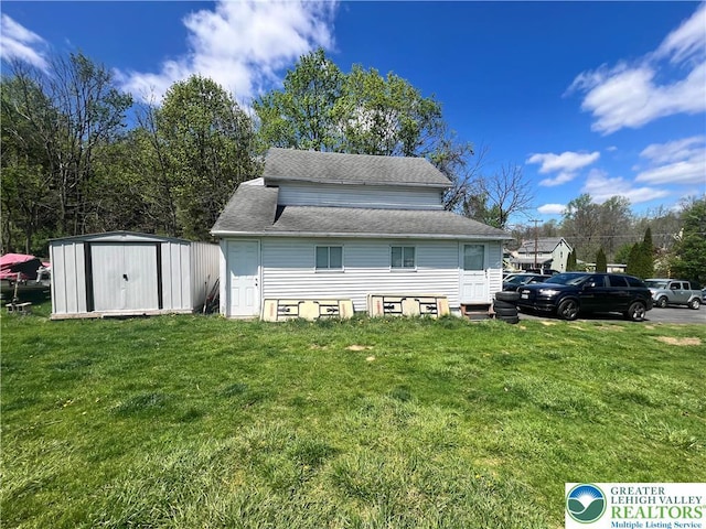 8204 Brown St, Washington Twp, PA 18079 - view of home's exterior with a storage shed, an outdoor structure, a shingled roof, and a lawn