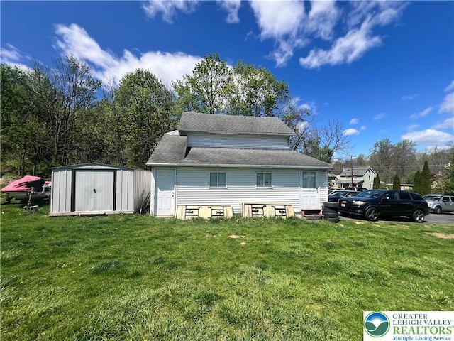 8204 Brown St, Washington Twp, PA 18079 - back of property with roof with shingles, an outbuilding, a yard, and a shed