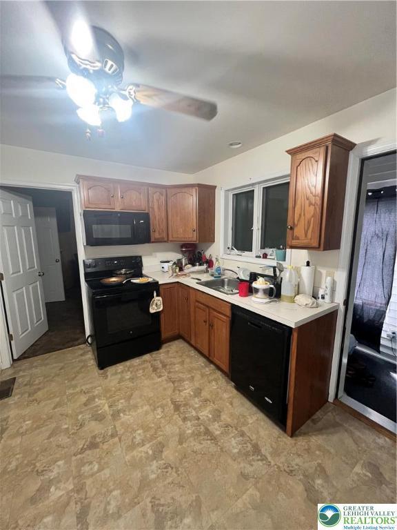 8204 Brown St, Washington Twp, PA 18079 - kitchen with brown cabinetry, ceiling fan, light countertops, a sink, and black appliances