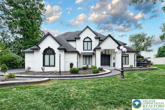 1231 Oakside Dr, Hanover Twp, PA 18017 - french country home with brick siding, fence, a front yard, and roof with shingles