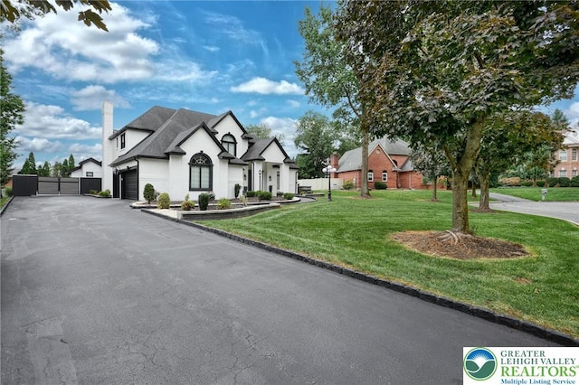 1231 Oakside Dr, Hanover Twp, PA 18017 - french provincial home featuring driveway, a chimney, a front yard, a residential view, and a garage