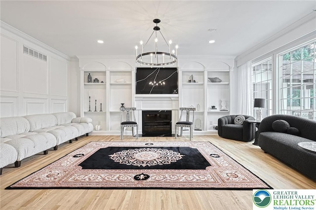 1231 Oakside Dr, Hanover Twp, PA 18017 - living room with a chandelier, visible vents, a fireplace with flush hearth, and wood finished floors