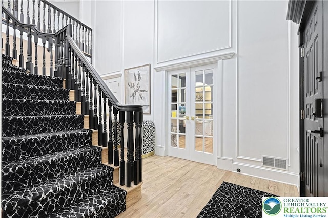 1231 Oakside Dr, Hanover Twp, PA 18017 - stairs with french doors, wood finished floors, and visible vents