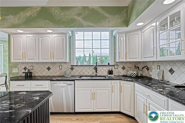 1231 Oakside Dr, Hanover Twp, PA 18017 - kitchen featuring stainless steel dishwasher, light wood-type flooring, a sink, dark stone counters, and white cabinetry