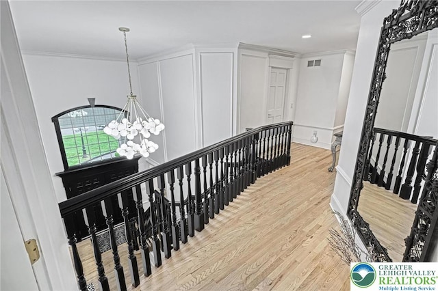 1231 Oakside Dr, Hanover Twp, PA 18017 - hall with crown molding, a chandelier, an upstairs landing, light wood-type flooring, and visible vents