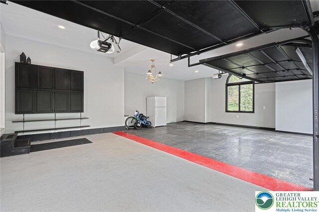 1231 Oakside Dr, Hanover Twp, PA 18017 - garage with baseboards, freestanding refrigerator, and a garage door opener