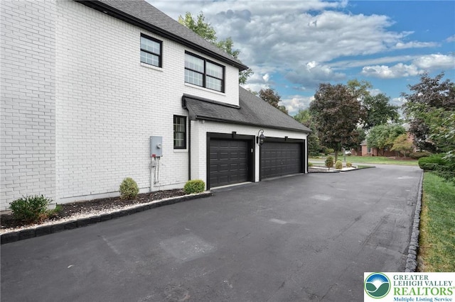 1231 Oakside Dr, Hanover Twp, PA 18017 - view of home's exterior featuring brick siding, driveway, a shingled roof, and a garage