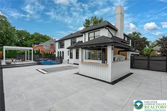 1231 Oakside Dr, Hanover Twp, PA 18017 - back of house featuring a patio, fence, a chimney, and a shingled roof