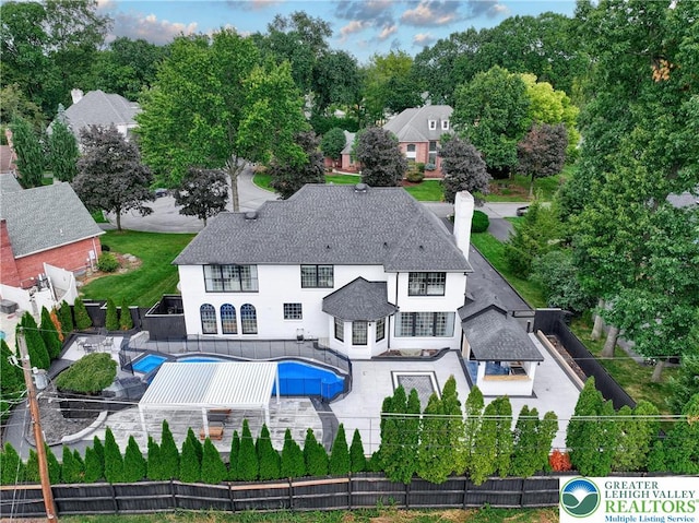 1231 Oakside Dr, Hanover Twp, PA 18017 - rear view of house with a fenced backyard, a fenced in pool, a patio, and a chimney