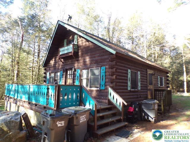 rear view of house with log exterior