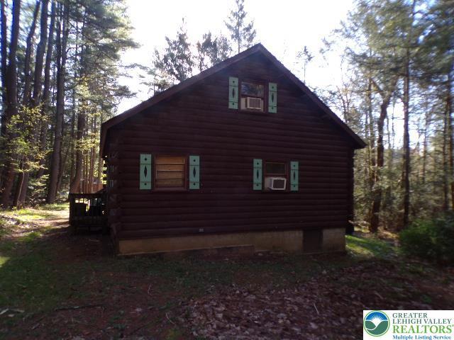 view of property exterior with log exterior and cooling unit