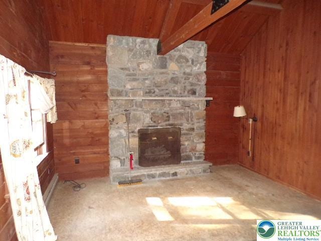 unfurnished living room featuring wooden ceiling, lofted ceiling with beams, wood walls, and a stone fireplace