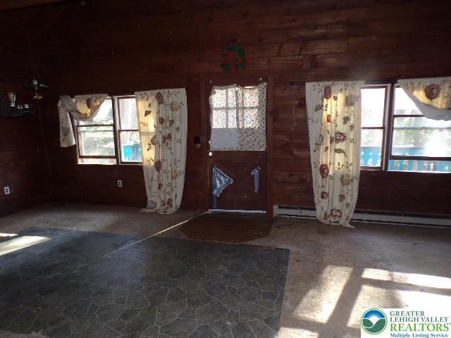 entrance foyer featuring wood walls