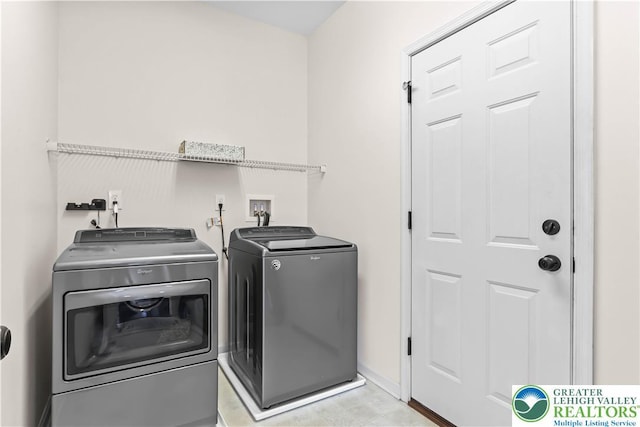 washroom featuring laundry area and washing machine and clothes dryer